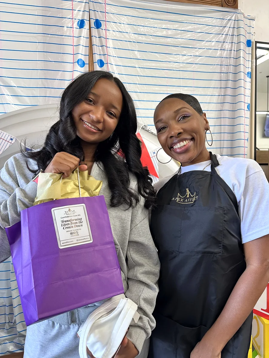 Crowned & Ready 2026: Two smiling participants holding a purple gift bag