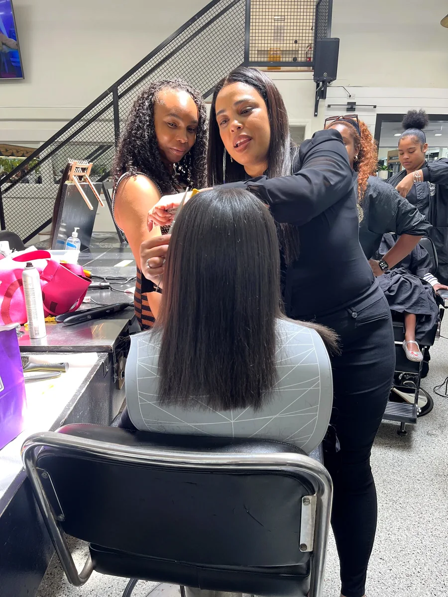 Crowned & Ready 2026: A finished hairstyle with stylists standing beside the participant