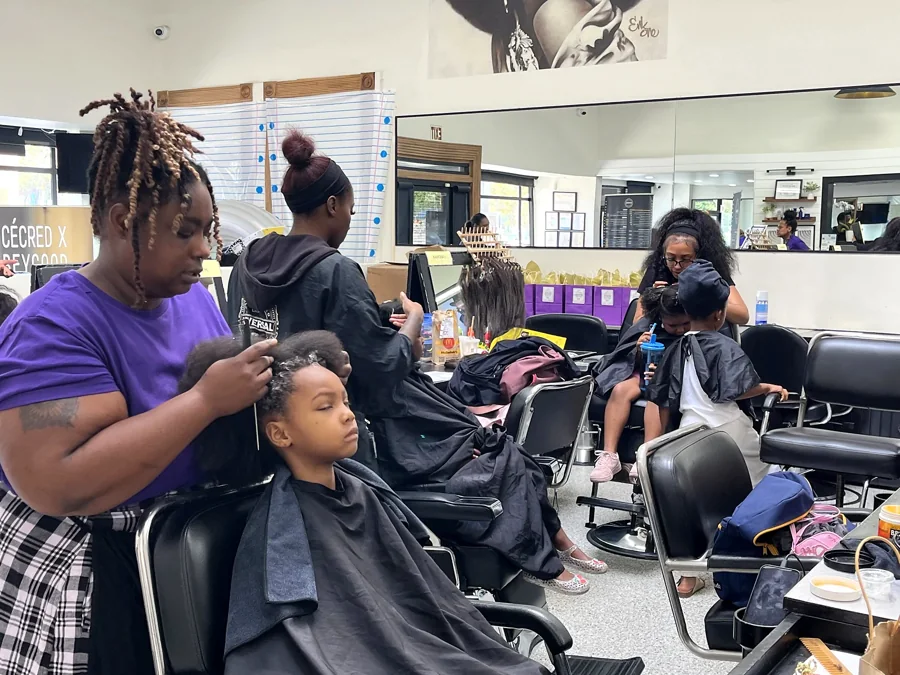 Crowned & Ready 2026: A stylist braiding a child’s hair during the event