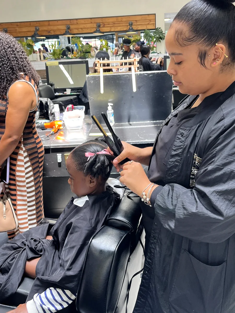 Crowned & Ready 2026: A stylist working carefully on a child’s hair